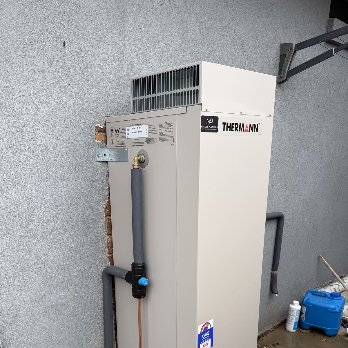 Thermann gas hot water unit installed against an exterior wall